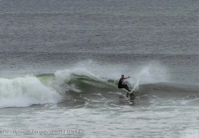 a kitchen with a sink a stove a refrigerator and white cabinets