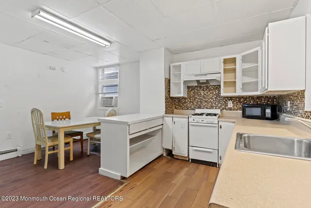 an aerial view of a city with ocean view in back