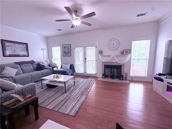 a living room with furniture a fireplace and a large window