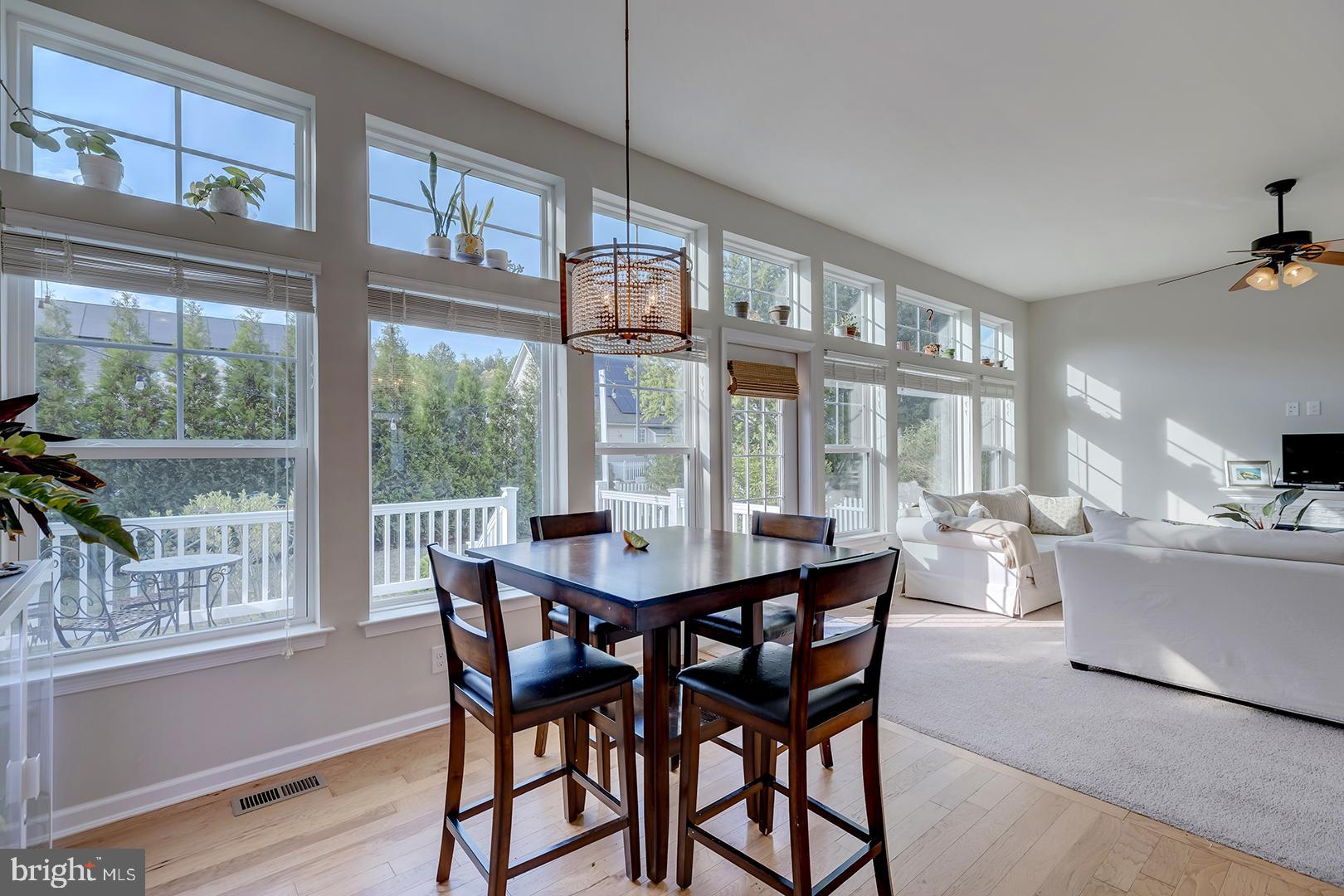 117 Carriage Drive Milton, DE 19968 - Photo 15 of 62 a view of a dining room with furniture large windows and wooden floor