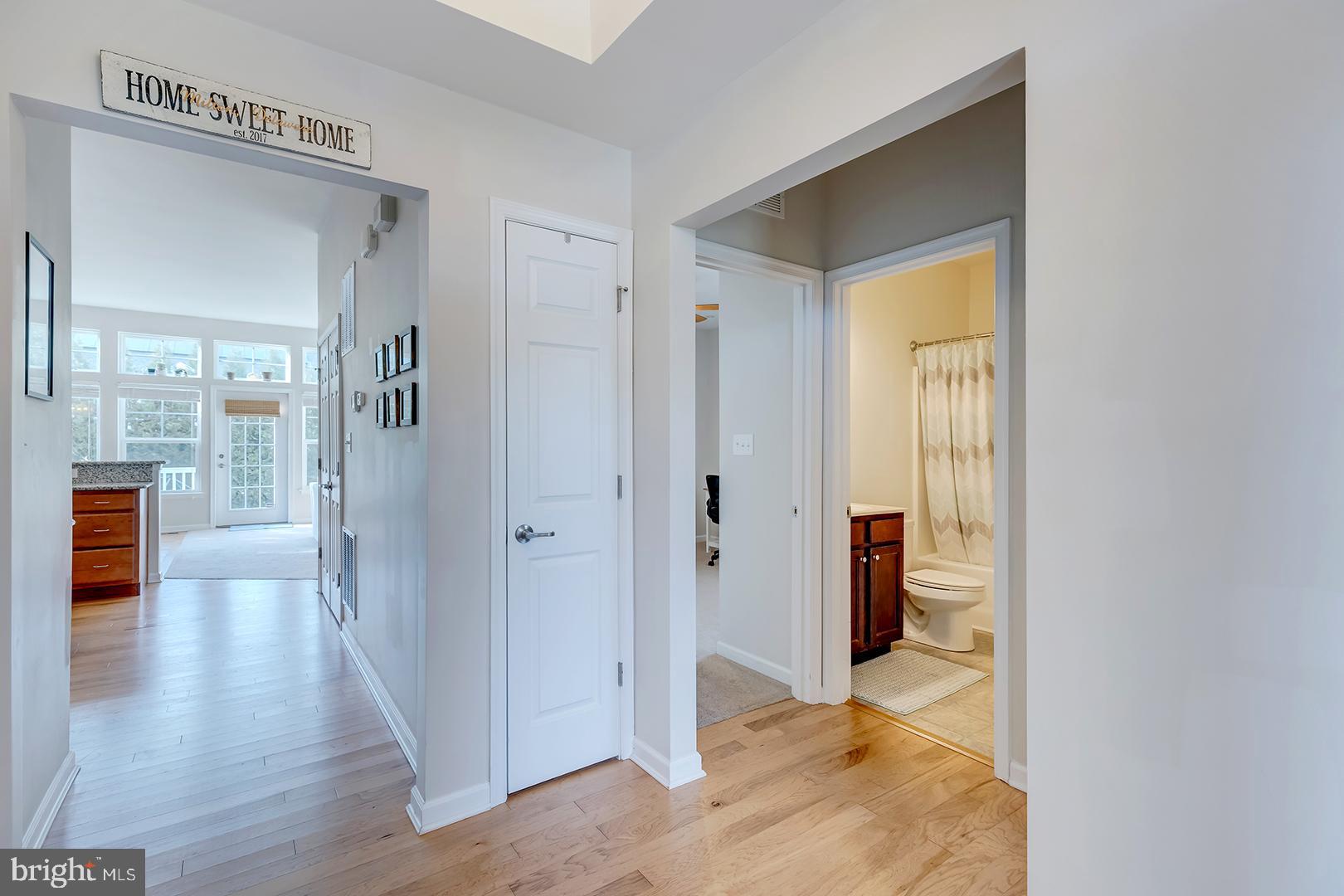 117 Carriage Drive Milton, DE 19968 - Photo 23 of 62 a view of a hallway with wooden floor and a bathroom