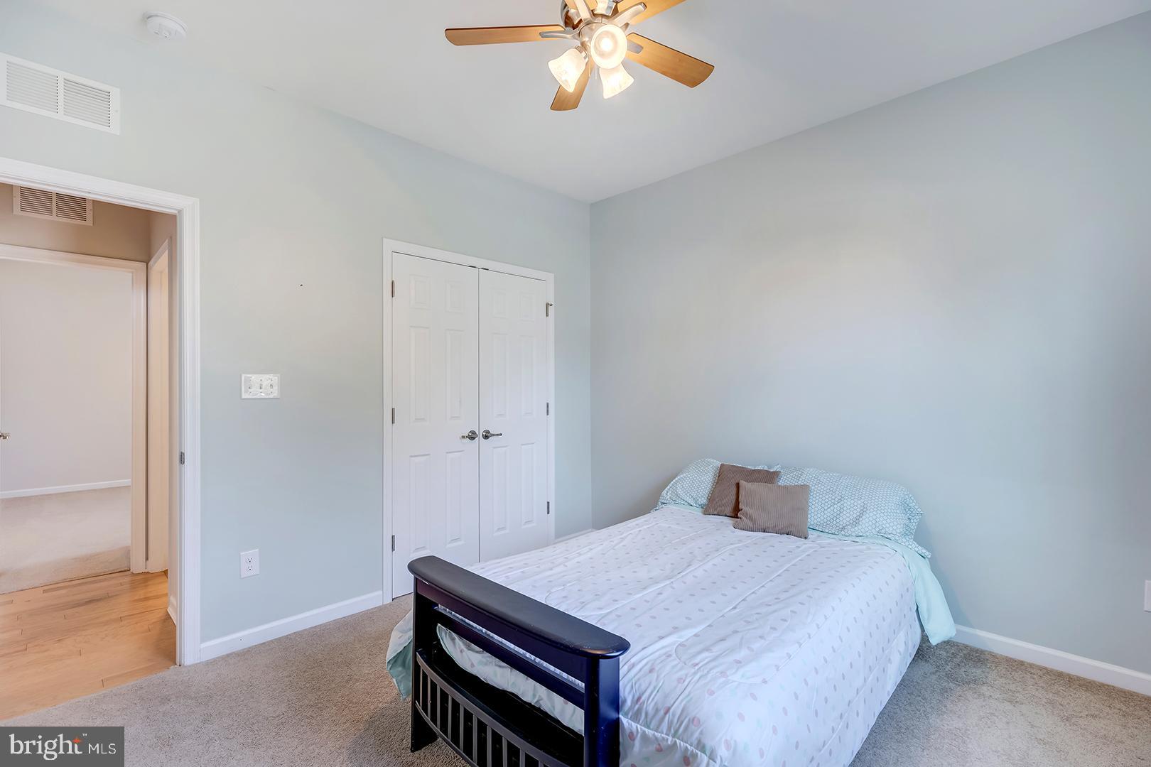 117 Carriage Drive Milton, DE 19968 - Photo 26 of 62 a bedroom with a bed and a chandelier