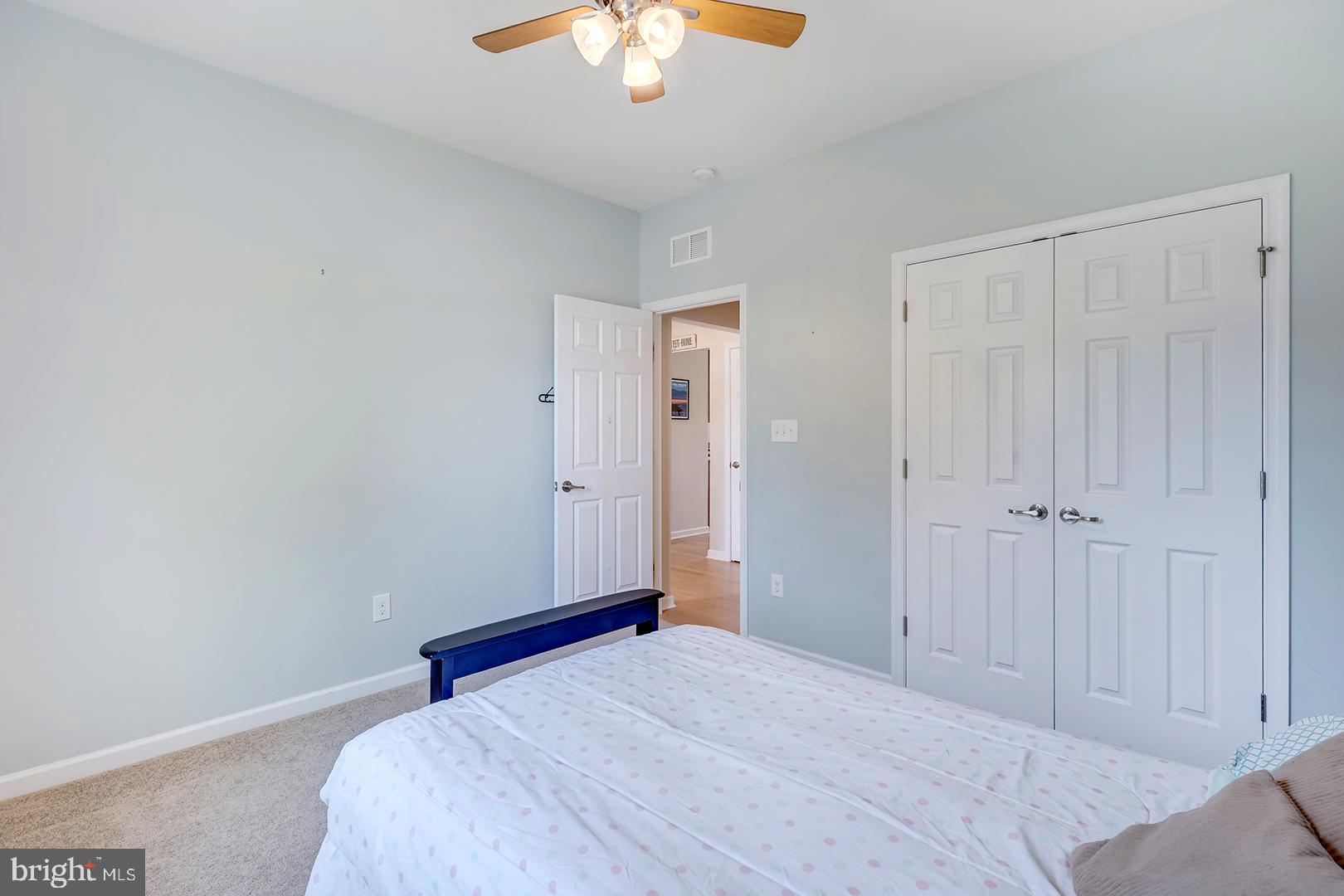 117 Carriage Drive Milton, DE 19968 - Photo 27 of 62 a bedroom with a bed and a chandelier fan