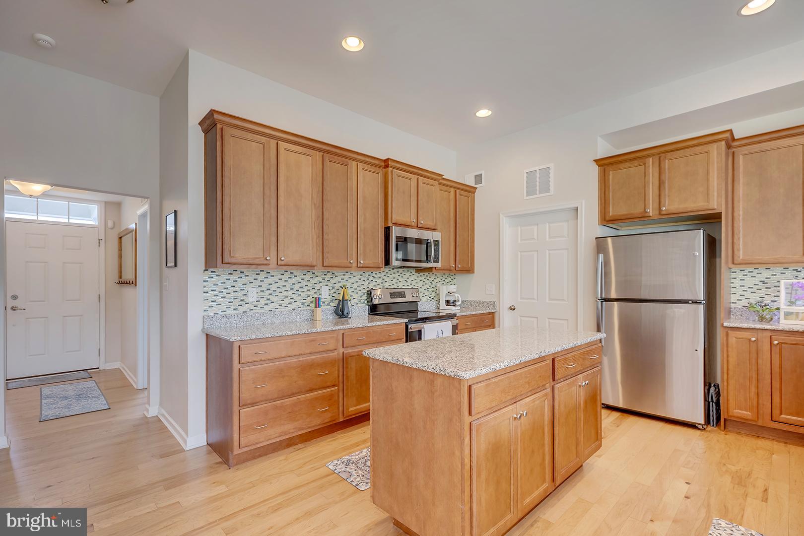 117 Carriage Drive Milton, DE 19968 - Photo 8 of 62 a kitchen with stainless steel appliances granite countertop a refrigerator sink and cabinets