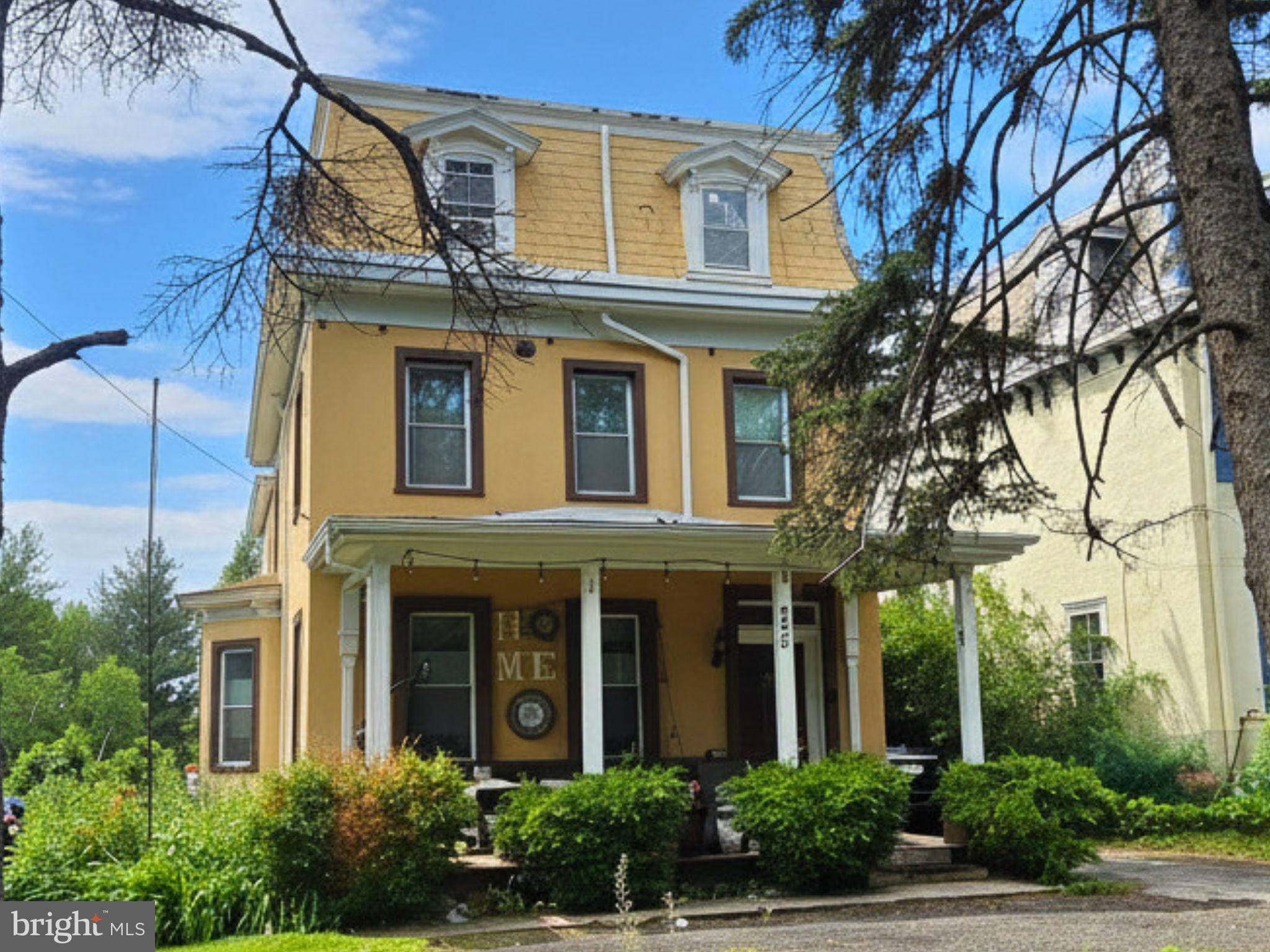 242 Church Road Elkins Park, PA 19027 - Photo 2 of 29 Charming yellow home with lush greenery.
