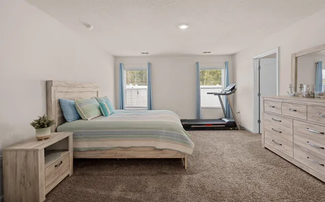 a bedroom with a bed and window