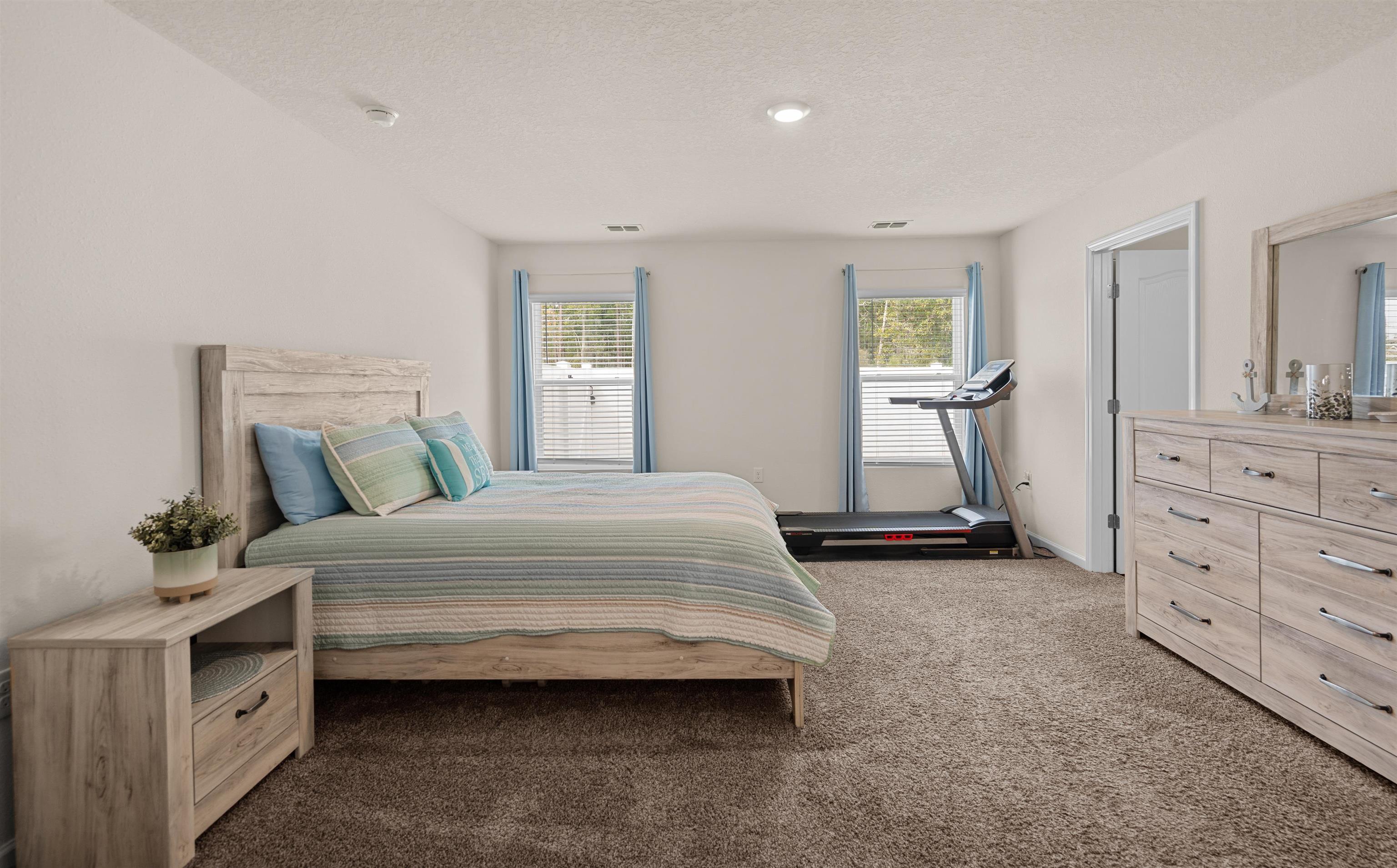 154 Falcon Ridge Road St. Augustine, FL 32084 - Photo 15 of 38 a bedroom with a bed and a dresser