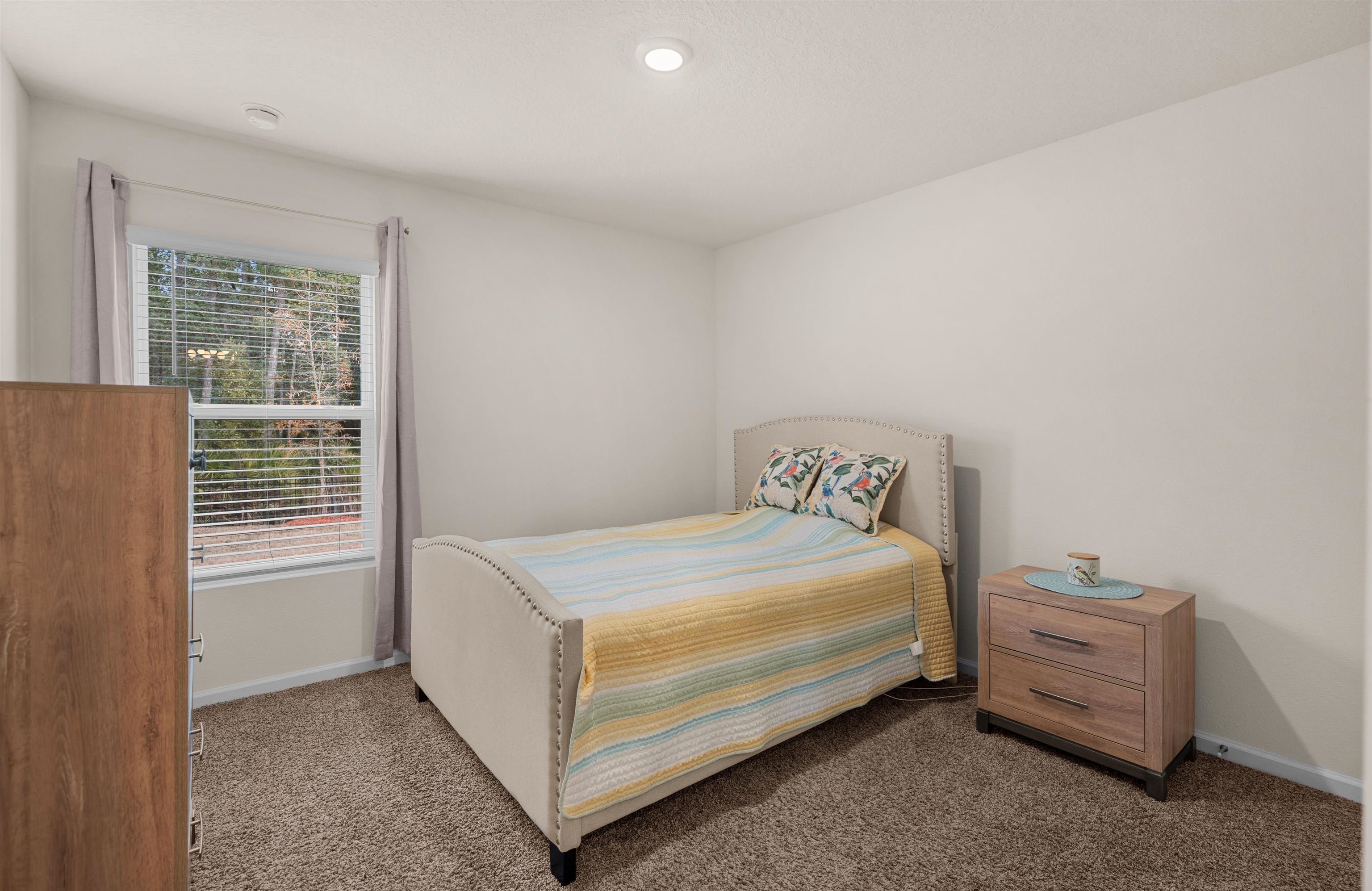 154 Falcon Ridge Road St. Augustine, FL 32084 - Photo 19 of 38 a bedroom with a bed and a window