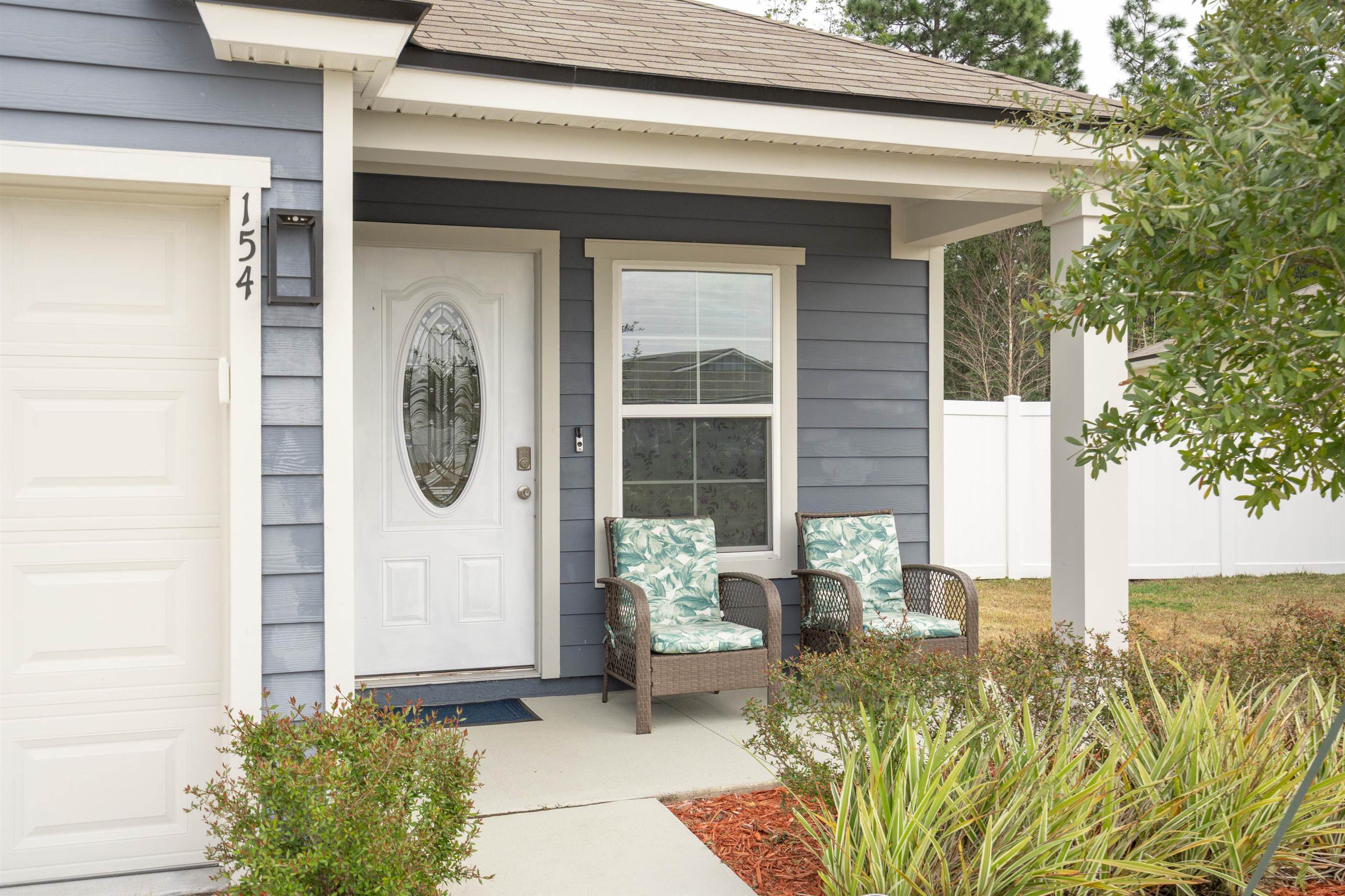 154 Falcon Ridge Road St. Augustine, FL 32084 - Photo 2 of 38 a front view of a house with garden