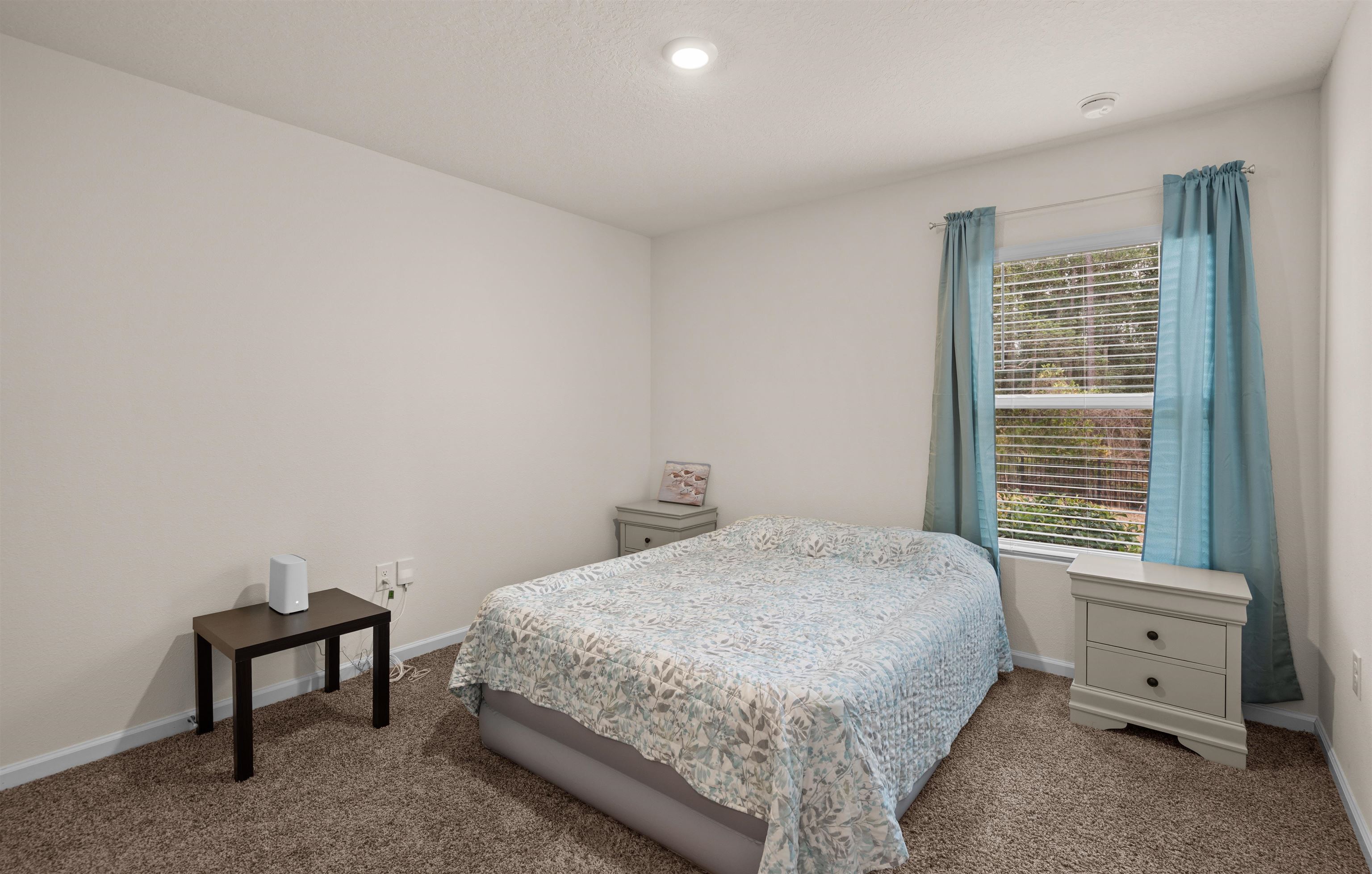 154 Falcon Ridge Road St. Augustine, FL 32084 - Photo 22 of 38 a bedroom with a bed and a window