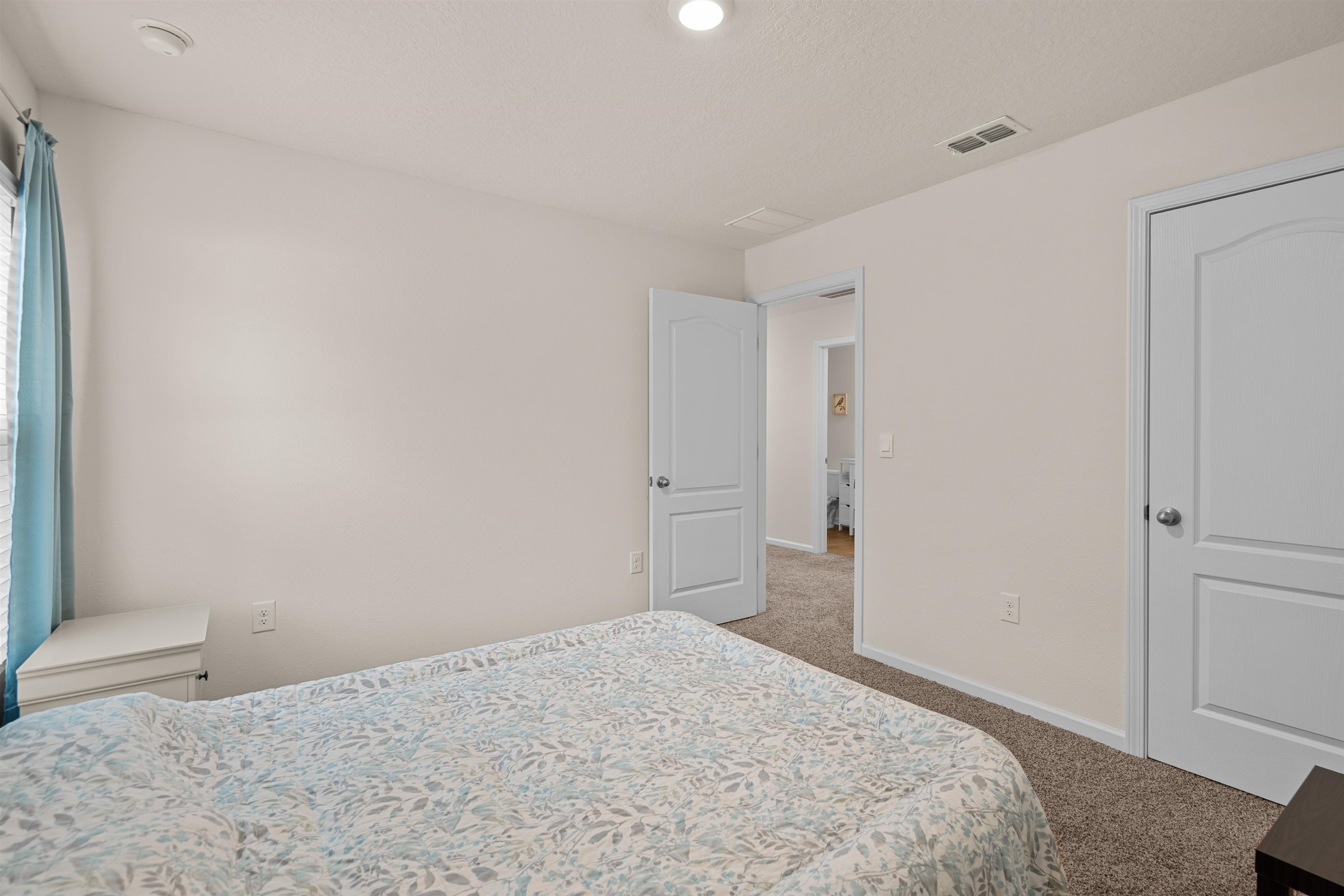 154 Falcon Ridge Road St. Augustine, FL 32084 - Photo 23 of 38 a bedroom with a bed and a window