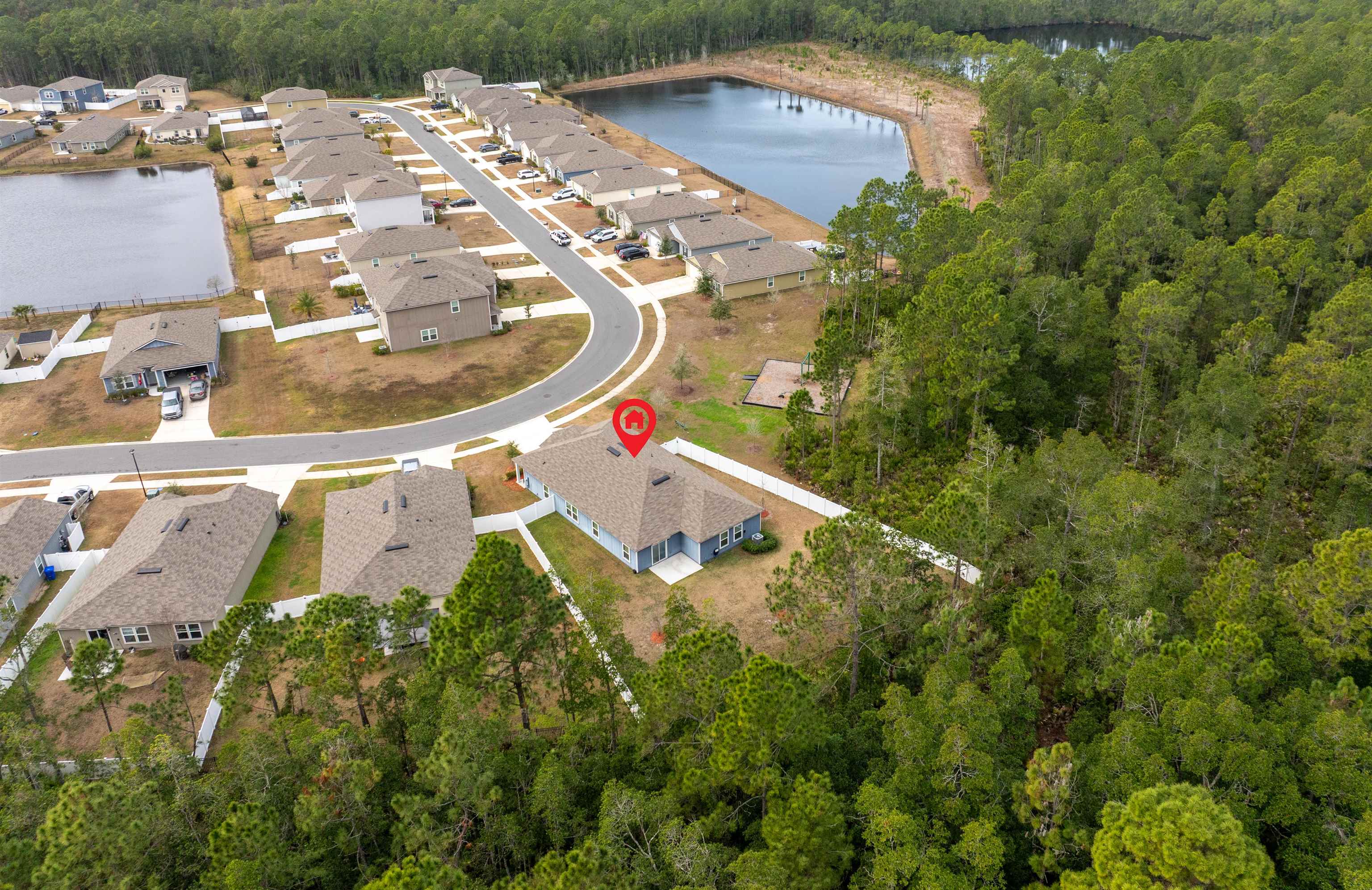 154 Falcon Ridge Road St. Augustine, FL 32084 - Photo 33 of 38 an aerial view of a house with a yard and lake