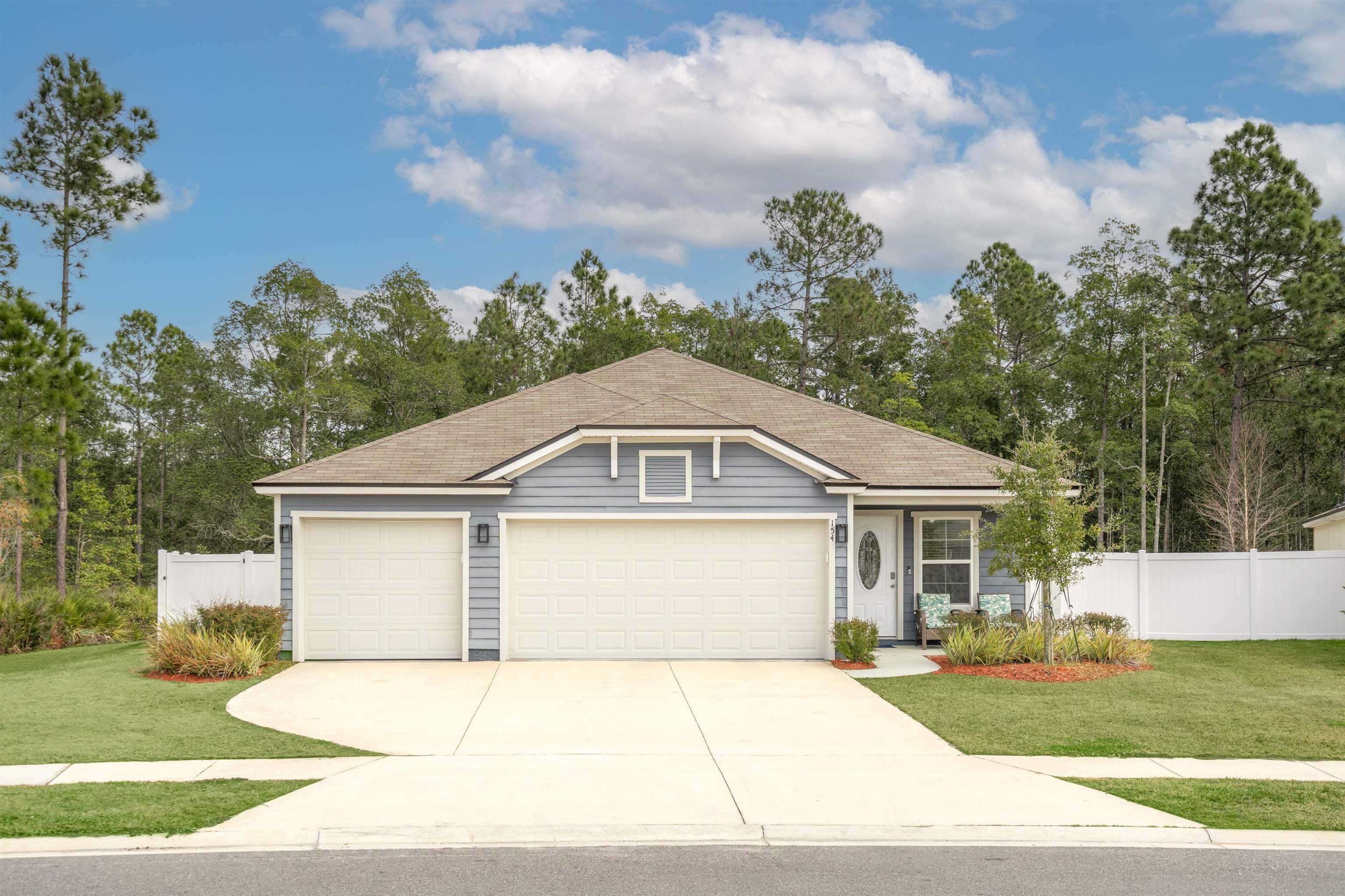 154 Falcon Ridge Road St. Augustine, FL 32084 - Photo 37 of 38 a front view of a house with a garden