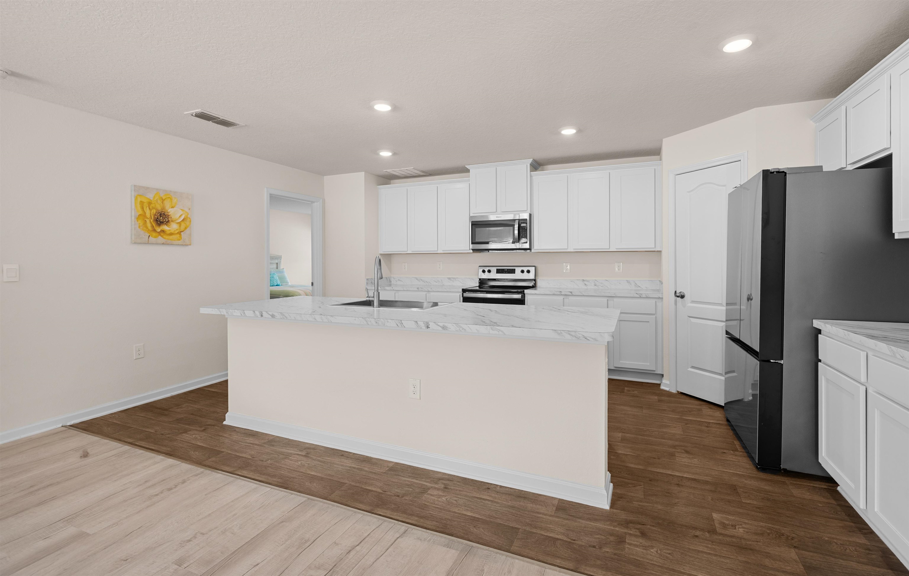 154 Falcon Ridge Road St. Augustine, FL 32084 - Photo 8 of 38 a kitchen with stainless steel appliances a refrigerator sink and white cabinets