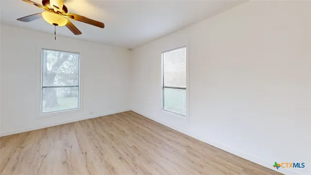 wooden floor in an empty room with a window