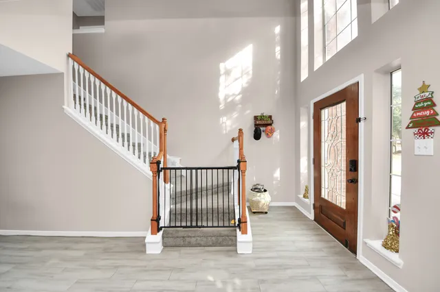 a view of a hallway with wooden floor and windows