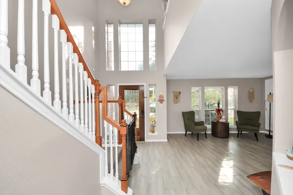 a view of an entryway with wooden floor and windows