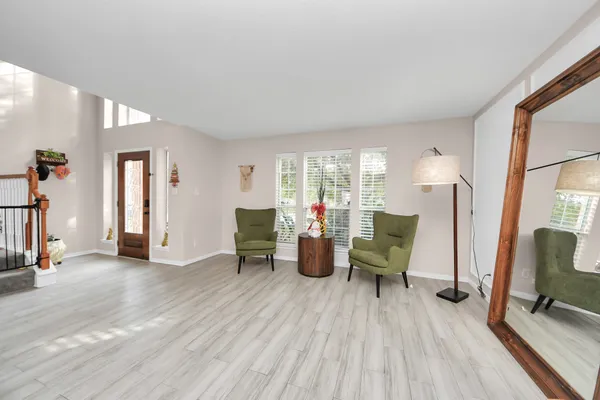 a living room with furniture and a wooden floor