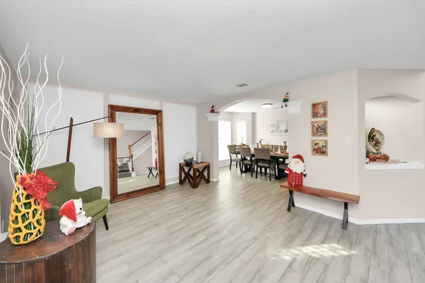 a living room with furniture and wooden floor