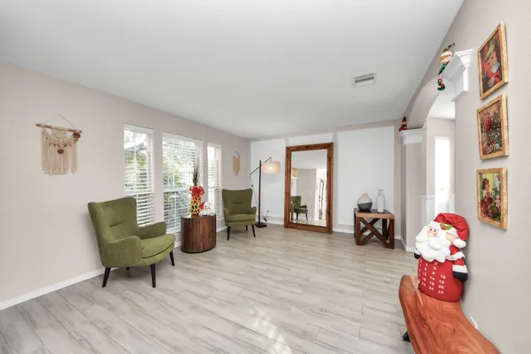 a living room with furniture and a wooden floor