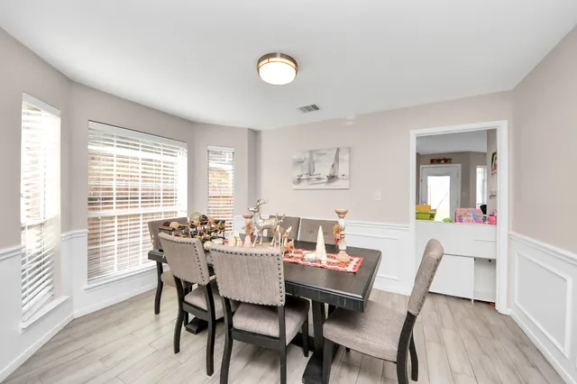 a view of a dining room with furniture and wooden floor