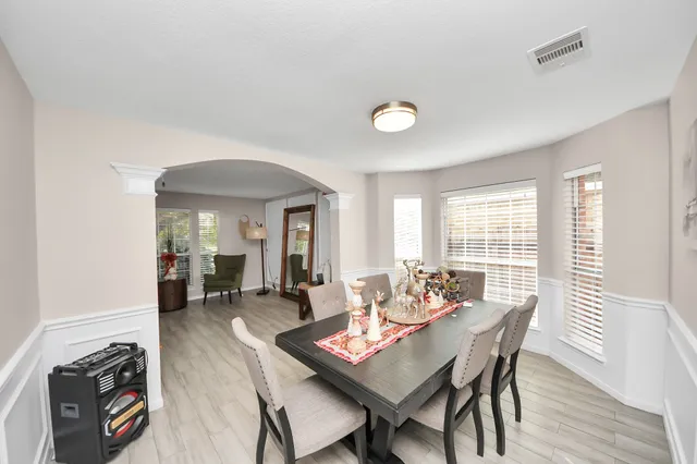 a dining room with furniture and window