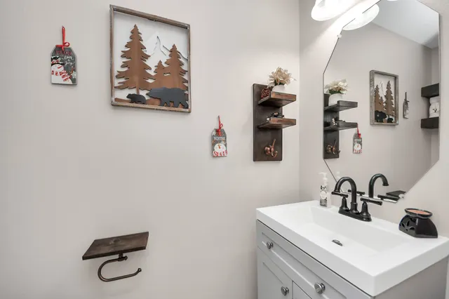 a bathroom with a sink mirror and vanity