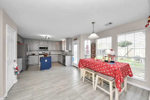 a dining room with furniture window and wooden floor