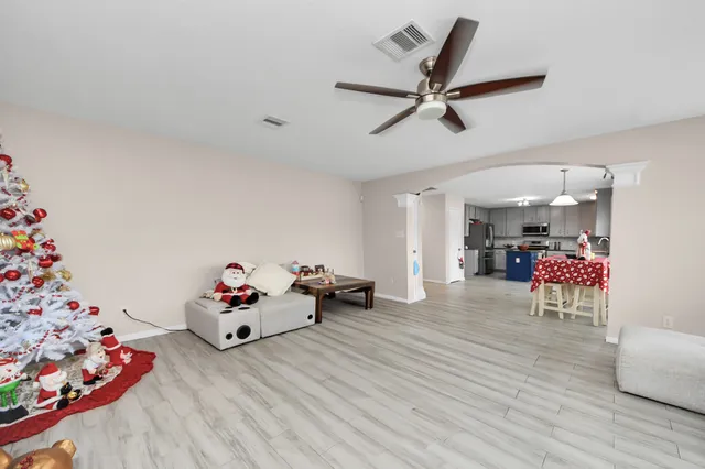 a living room with furniture and a wooden floor