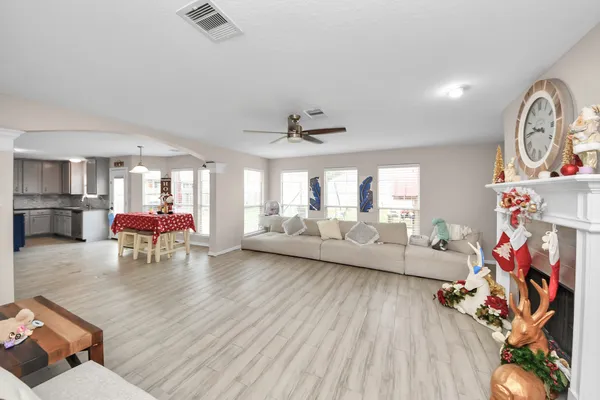 a living room with furniture and a wooden floor