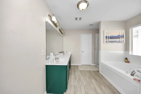 a bathroom with a double vanity sink and a mirror