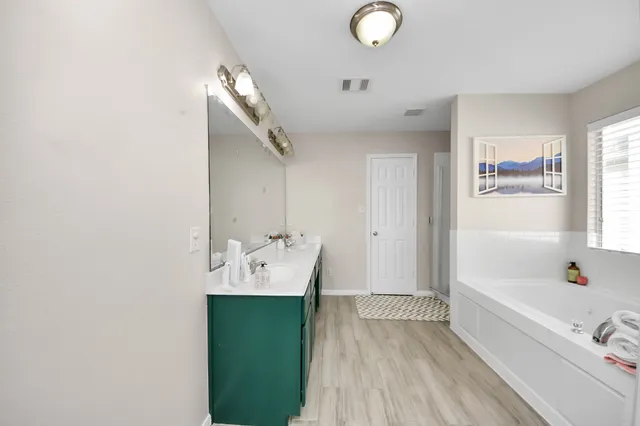 a bathroom with a double vanity sink and a mirror
