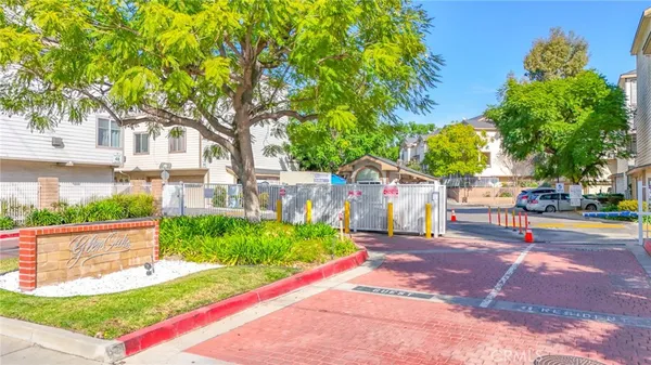 a front view of a house with a yard and potted plants