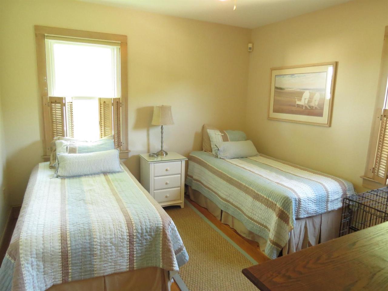 40 Wadsworth Road Chatham, MA 02659 - Photo 14 of 25 a bedroom with a bed and wooden floor