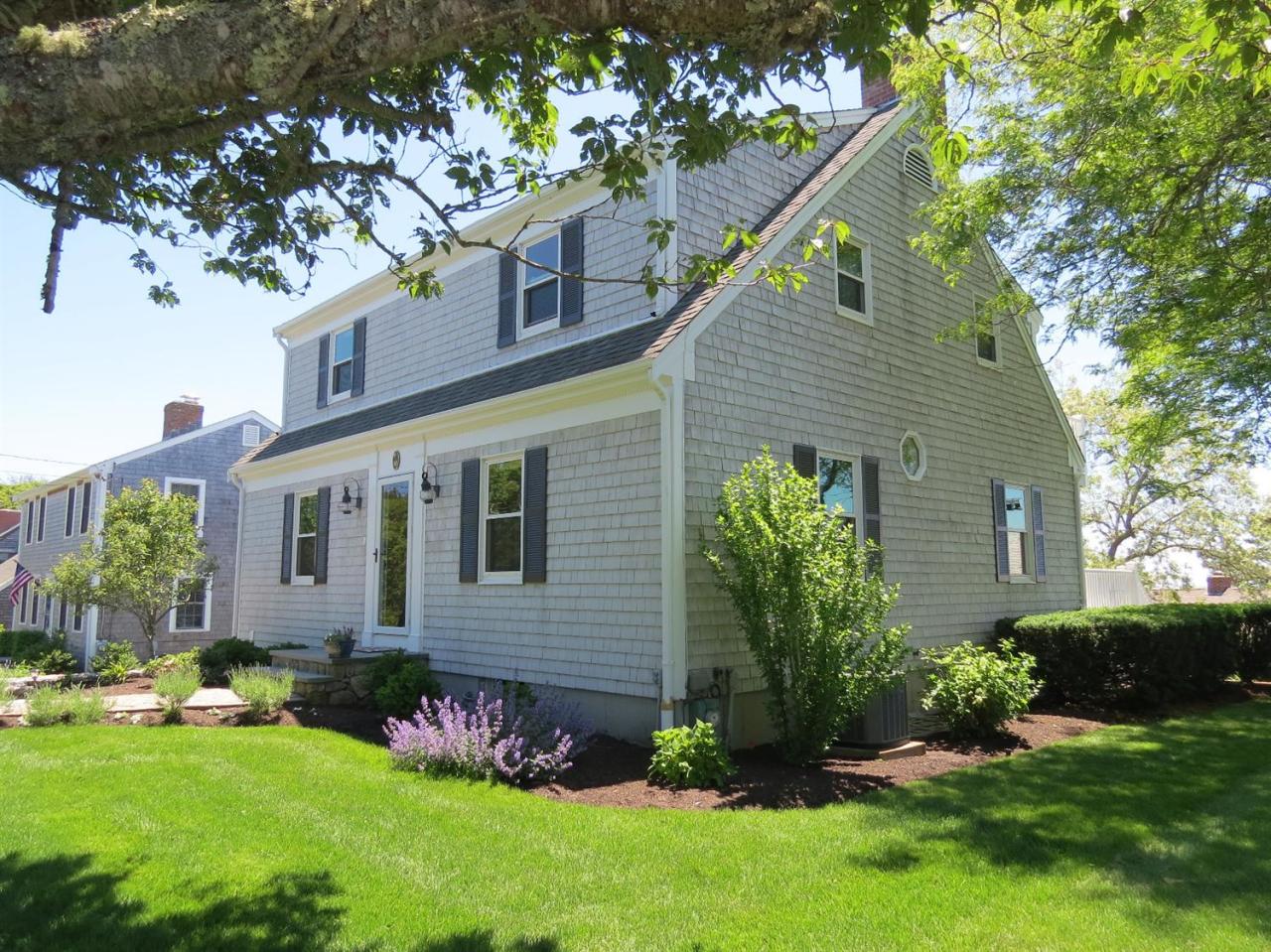 40 Wadsworth Road Chatham, MA 02659 - Photo 3 of 25 a front view of a house with a garden and plants