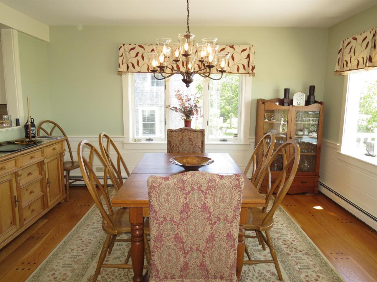 40 Wadsworth Road Chatham, MA 02659 - Photo 6 of 25 a view of a dining room with furniture a chandelier and wooden floor