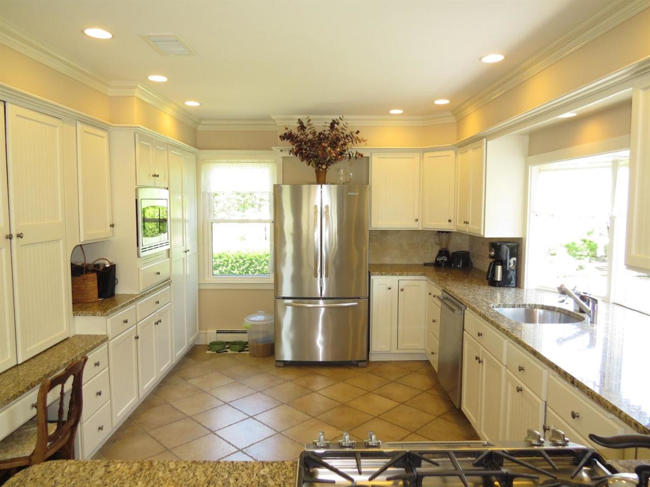 40 Wadsworth Road Chatham, MA 02659 - Photo 8 of 25 a kitchen with stainless steel appliances a refrigerator sink and cabinets