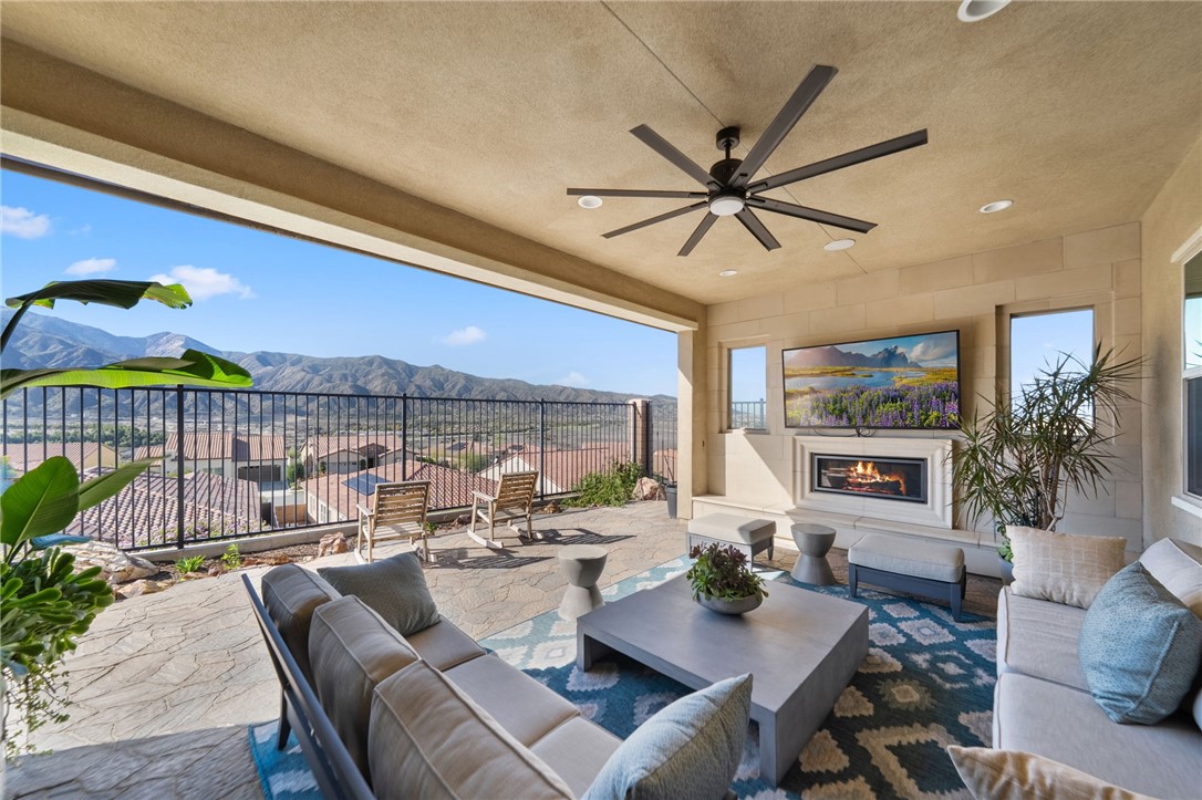 a living room with furniture a chandelier and a dining table with wooden floor