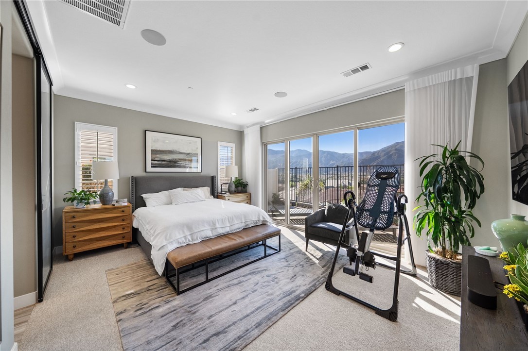 11463 Explorer Court Temescal Valley, CA 92883 - Photo 30 of 59 a spacious bedroom with a large bed and a potted plant
