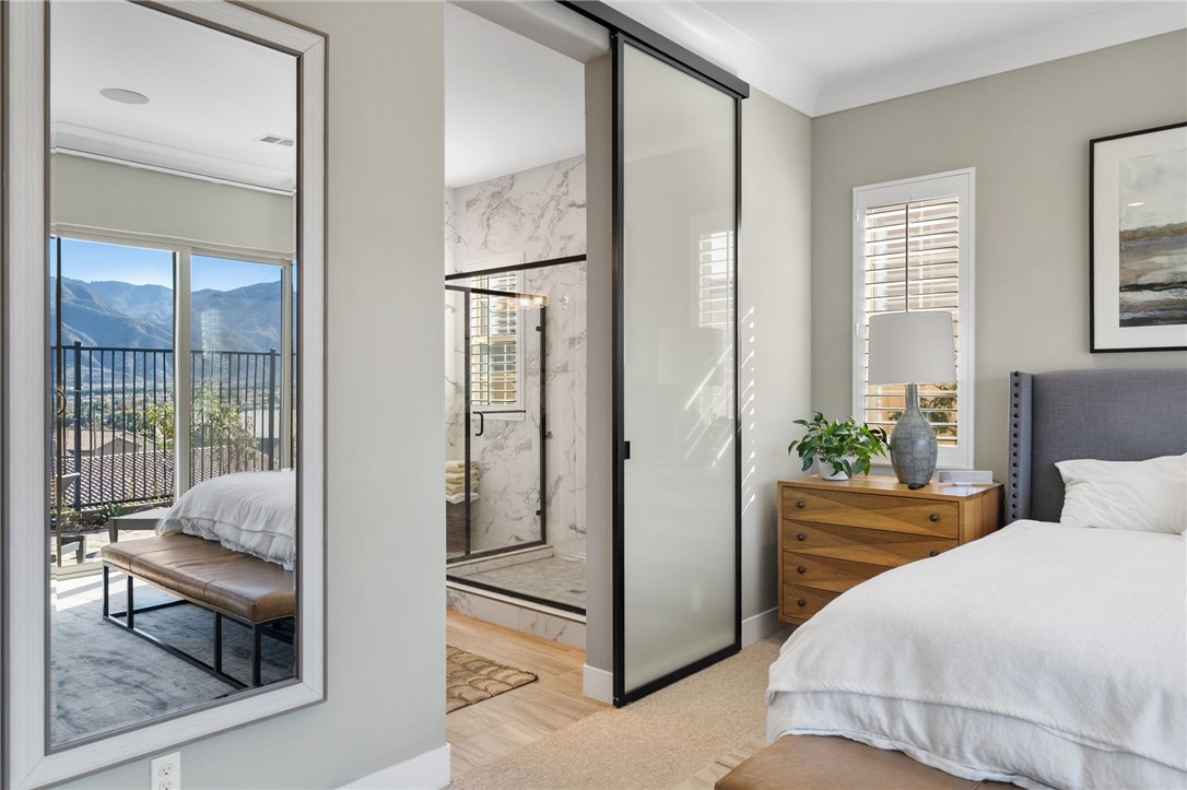 11463 Explorer Court Temescal Valley, CA 92883 - Photo 32 of 59 a bedroom with a bed and large windows