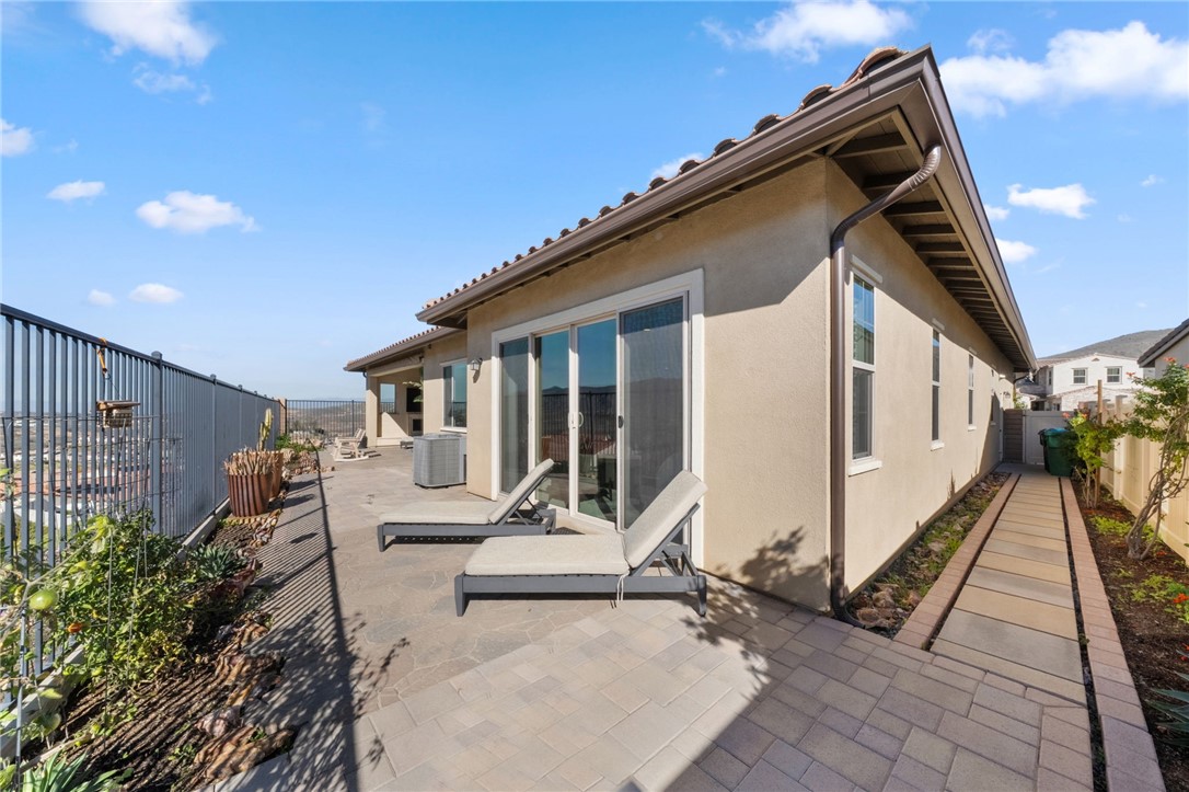 11463 Explorer Court Temescal Valley, CA 92883 - Photo 48 of 59 a view of house with a large window and potted plants