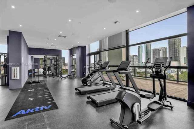 a view of a lobby with gym equipment and floor to ceiling window