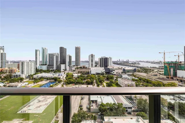 a city view from a balcony with furniture