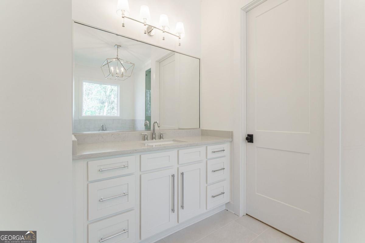 140 Parkside Lane Eatonton, GA 31024 - Photo 19 of 37 a bathroom with a double vanity sink and a mirror