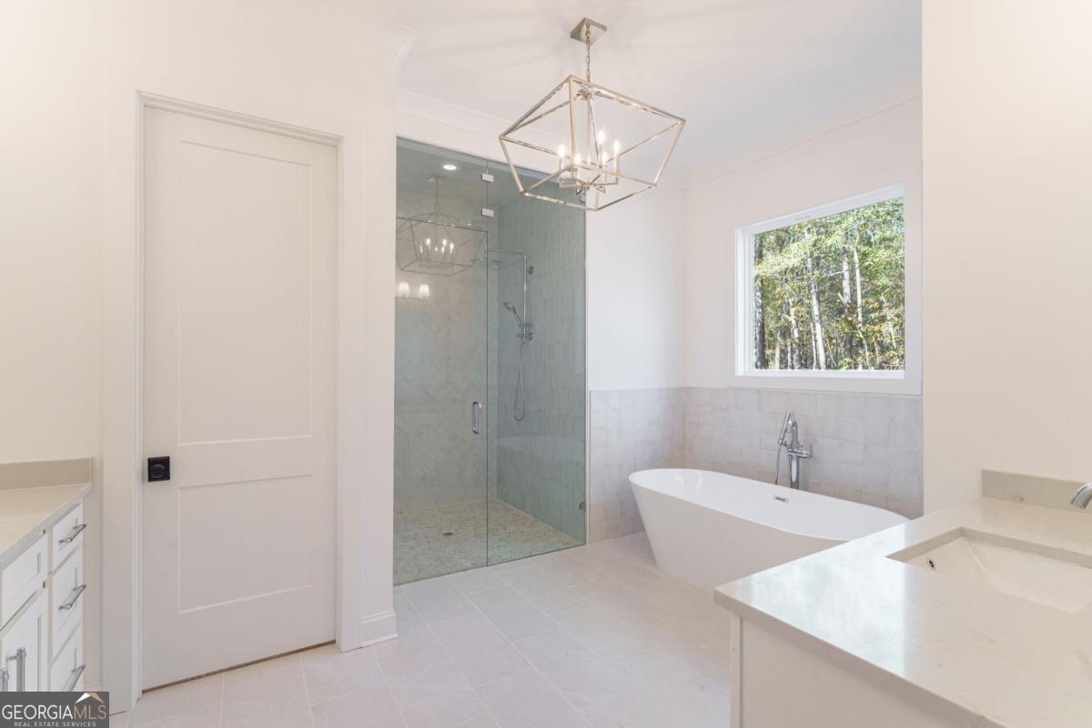 140 Parkside Lane Eatonton, GA 31024 - Photo 20 of 37 a bathroom with a tub shower and sink