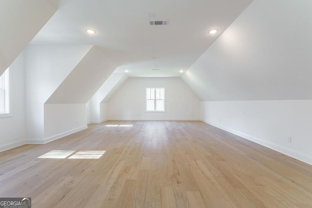 140 Parkside Lane Eatonton, GA 31024 - Photo 23 of 37 an empty room with wooden floor and windows
