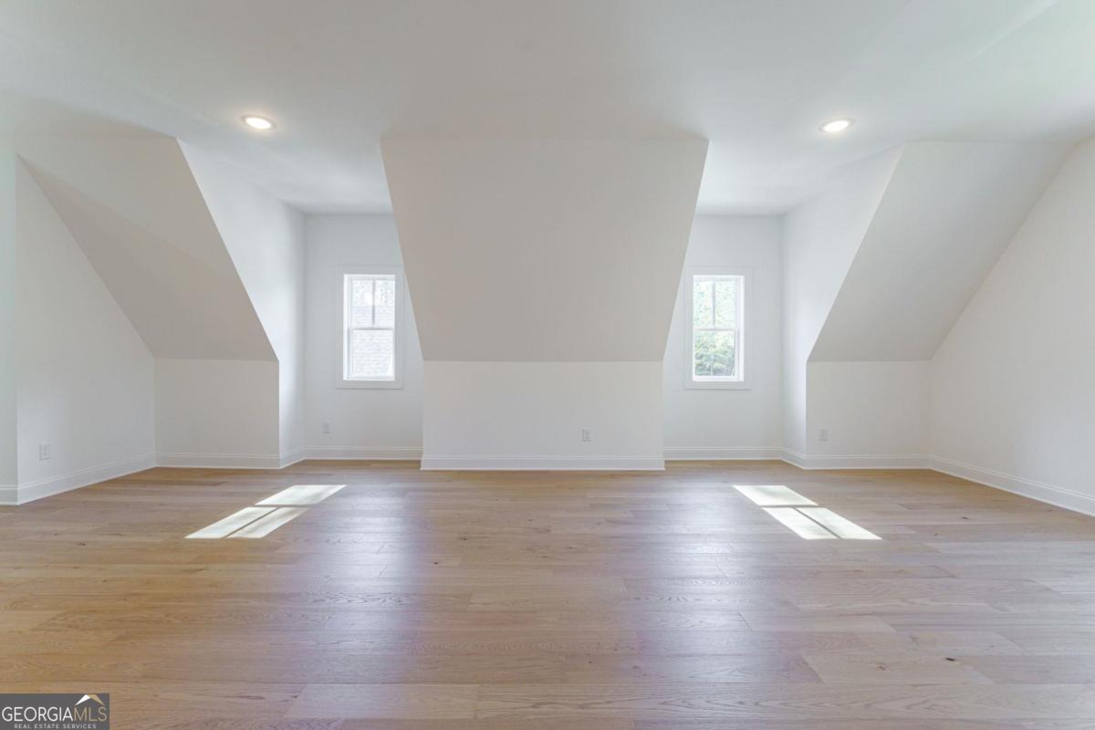 140 Parkside Lane Eatonton, GA 31024 - Photo 24 of 37 an empty room with wooden floor and windows