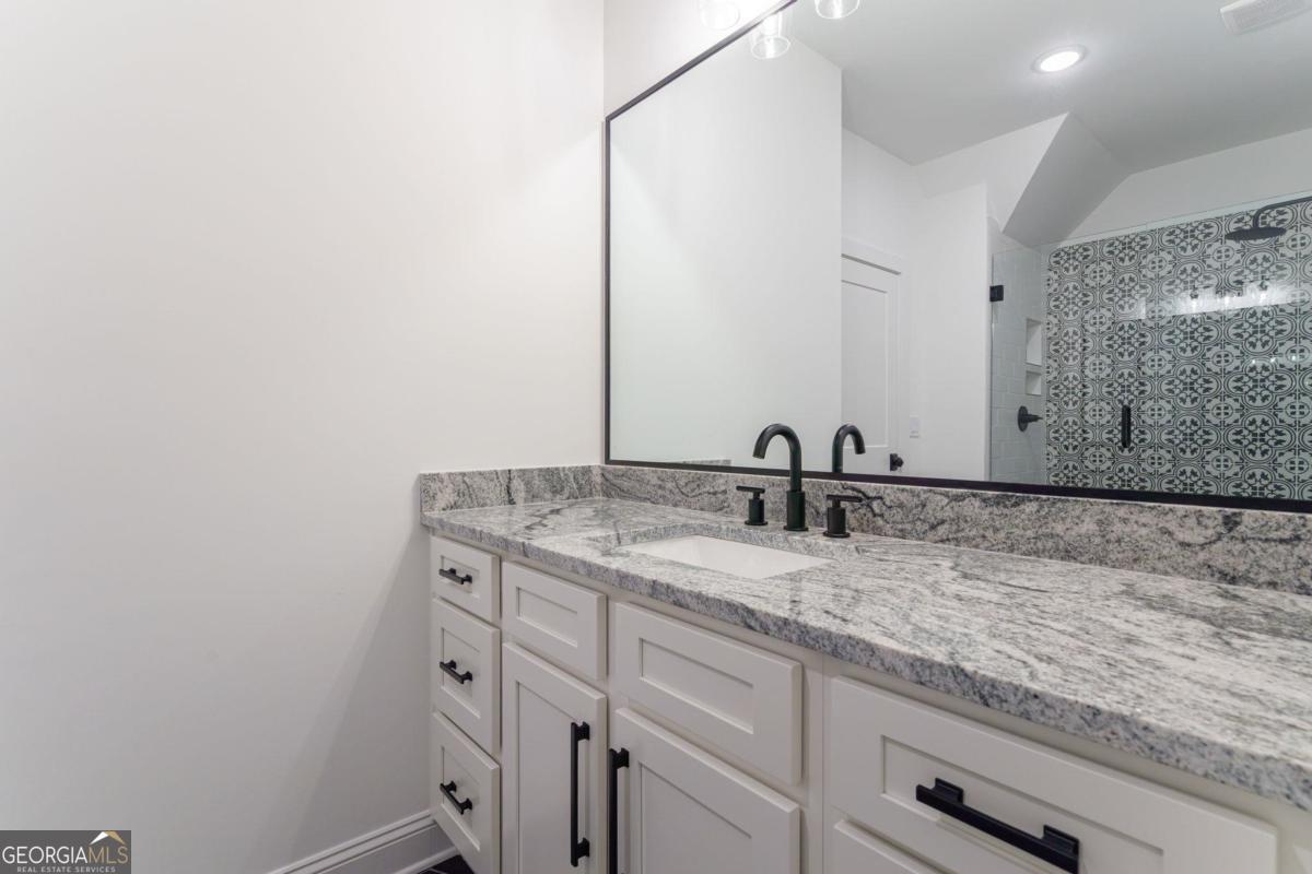 140 Parkside Lane Eatonton, GA 31024 - Photo 25 of 37 a bathroom with a granite countertop sink and a mirror