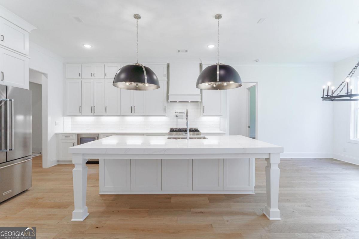 140 Parkside Lane Eatonton, GA 31024 - Photo 29 of 37 a kitchen with stainless steel appliances a sink a microwave a refrigerator and cabinets