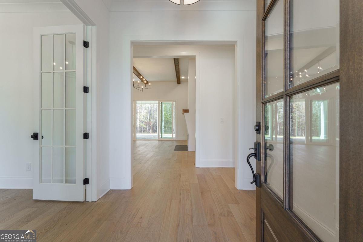 140 Parkside Lane Eatonton, GA 31024 - Photo 5 of 37 a view of a hallway with wooden floor